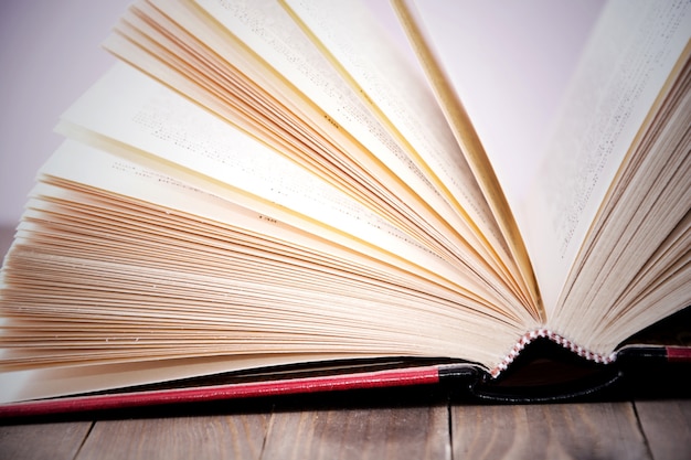 Free photo open book on wooden table.