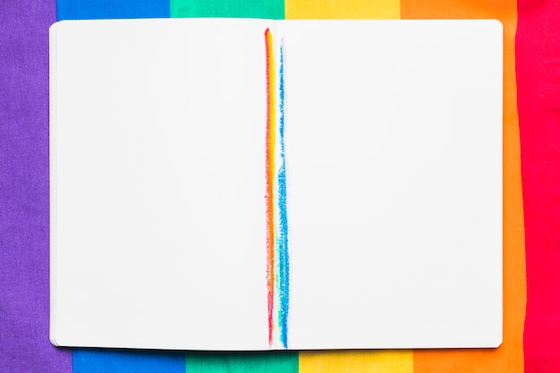 Open copybook with rainbow stripes