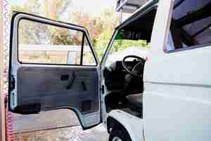 Free photo open door of a old white van