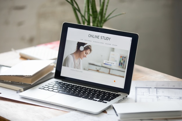 Open laptop on the desk, online study on the screen