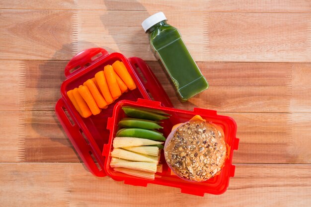 Open lunch box on wooden table