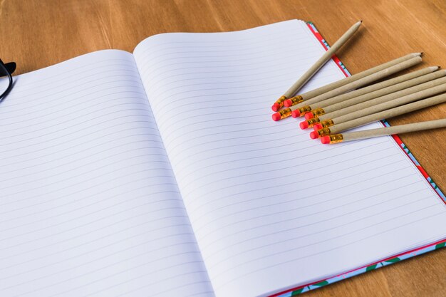 Open notebook with pencils on it