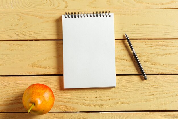 Open notepad on wooden background