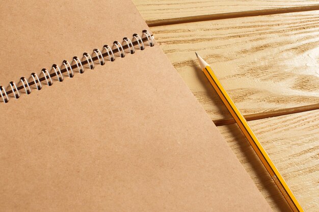 Open notepad on wooden background