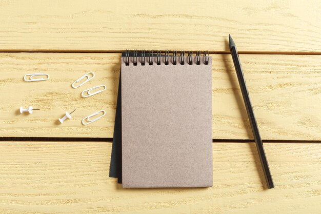 Open notepad on wooden background