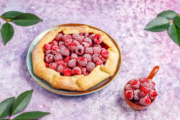 Open pie, raspberry galette. Summer berry dessert.