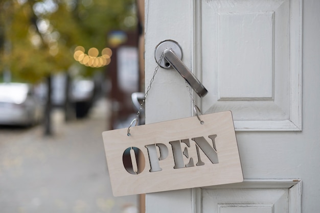 Free photo open sign hanging on doorknob