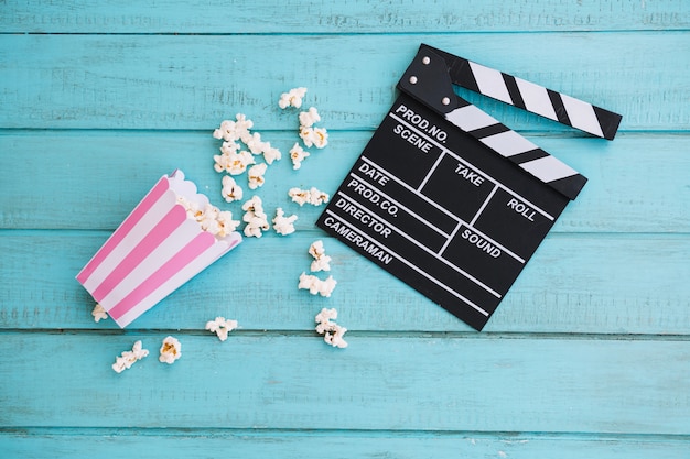 Opened clapperboard and popcorn box