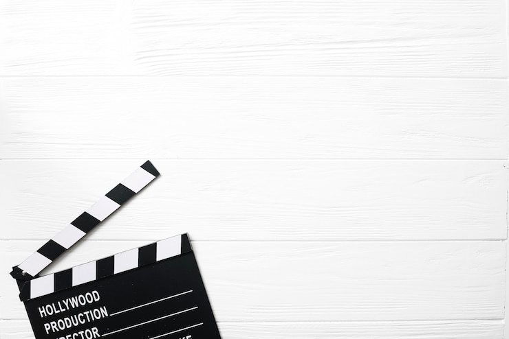 Free Photo opened clapperboard on white table