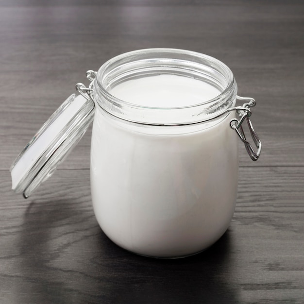 Opened jar with fresh milk