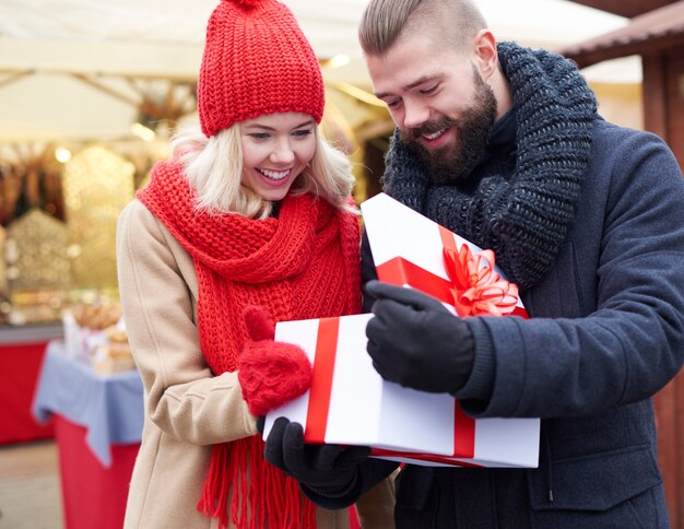 Opening big gift on christmas market