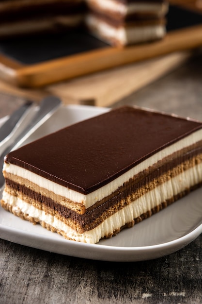 Opera cake dessert slice on wooden table