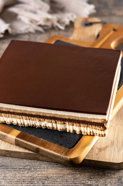 Opera cake dessert on wooden table