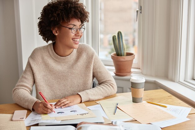 Optimistic clever freelancer working at home