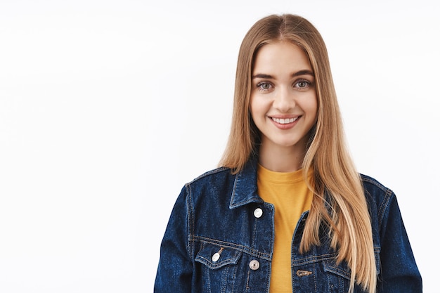 Optimistic, happy blond nice girl in denim jacket over t-shirt, looking at camera sincere smiling, express positive friendly attitude