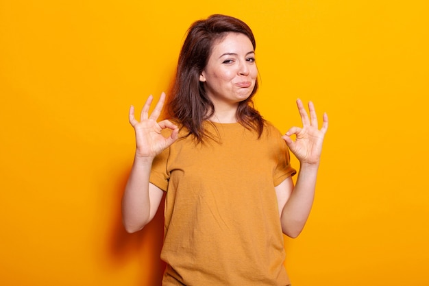 Optimistic person showing approval gesture on camera