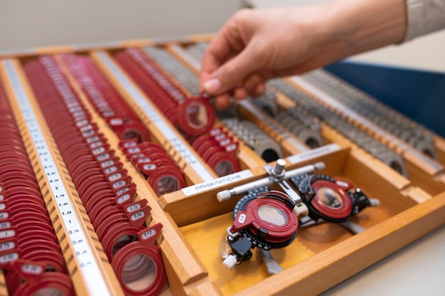 Optometrist choosing lenses for testing patient