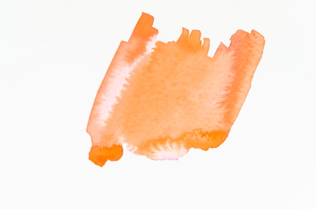 An orange abstract orange watercolor splash isolated on white backdrop