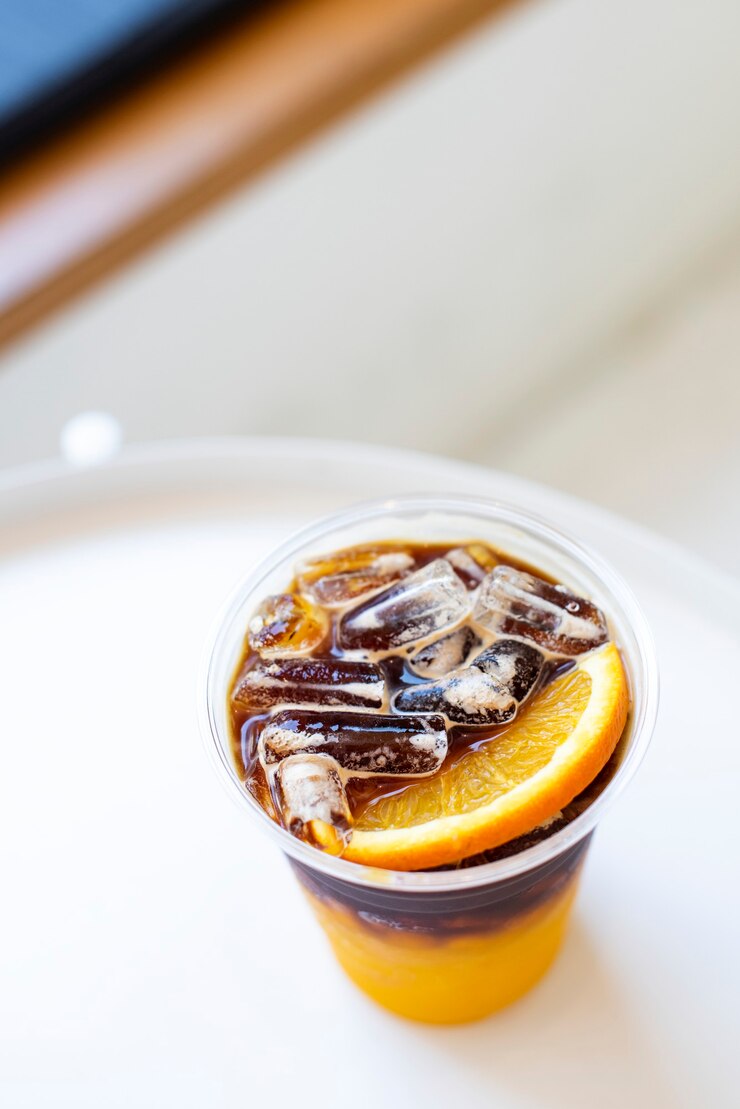Free Photo orange americano iced coffee at a cafe aerial view