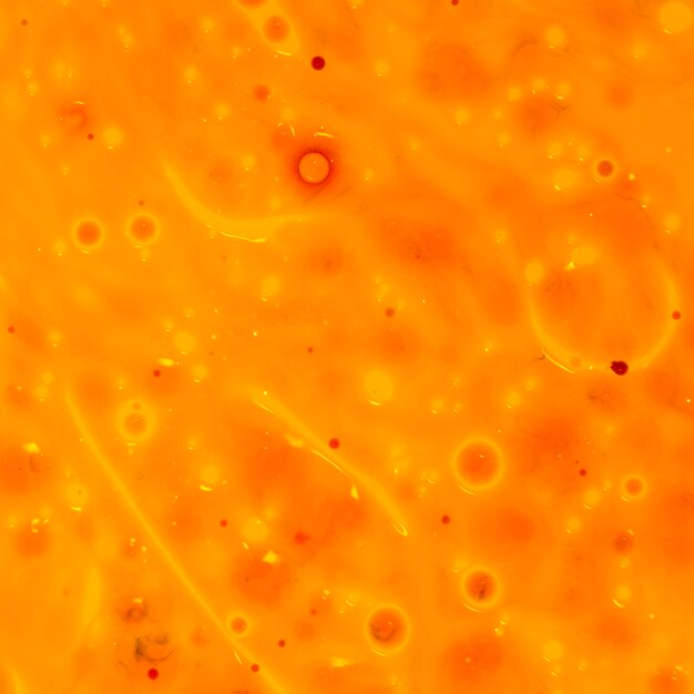 Free photo orange background with bubbles in oil