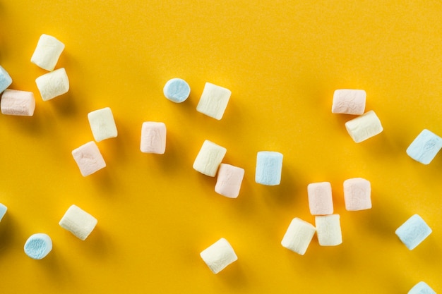 Orange background with colourful marshmallows