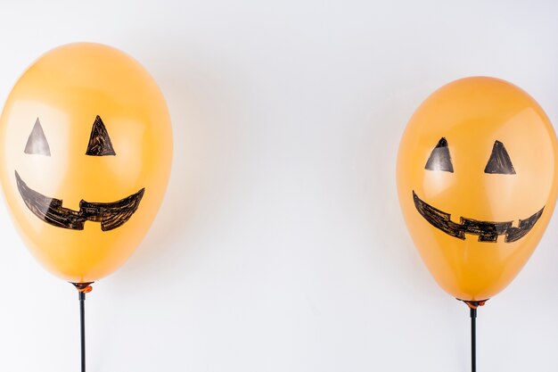 Orange balloons painted as pumpkins 