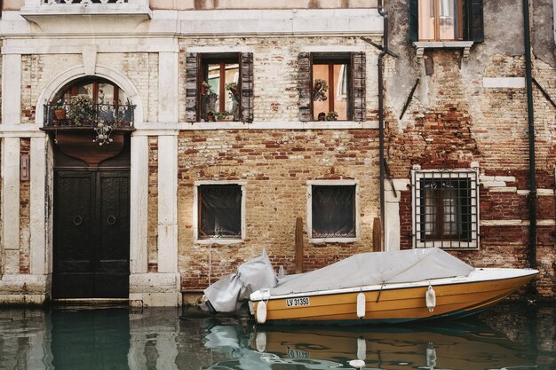 Orange boat in front of building