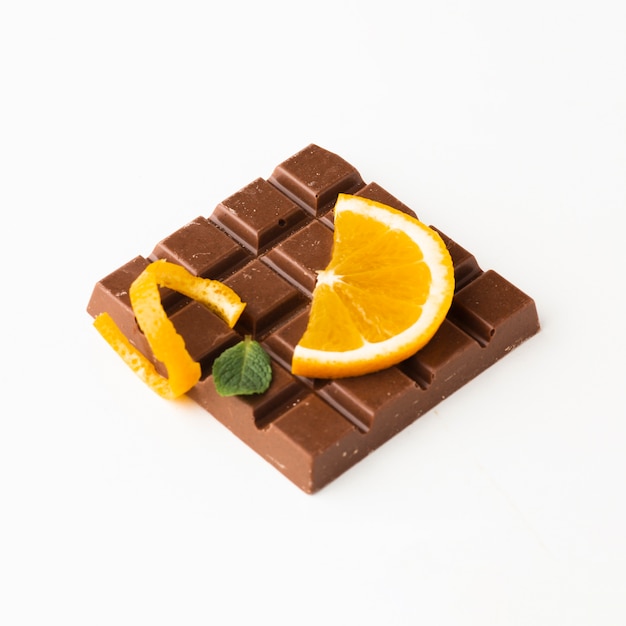 Orange on chocolate bar close up