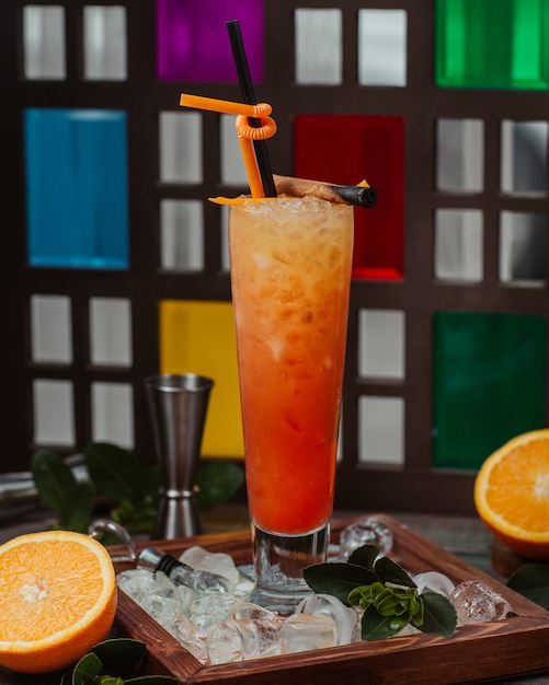 Free photo orange cocktail glass with pipe and minced ice cubes