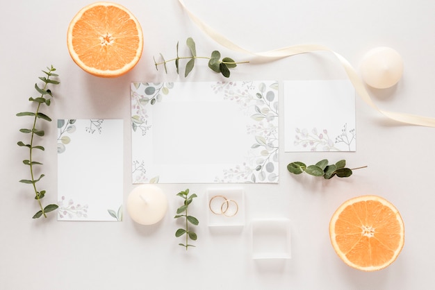 Free photo orange cut in half with wedding invitation