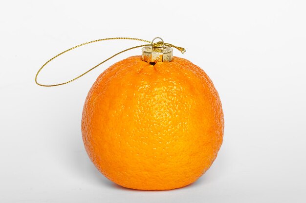 Free photo orange fruit as a christmas ball isolated on a white background