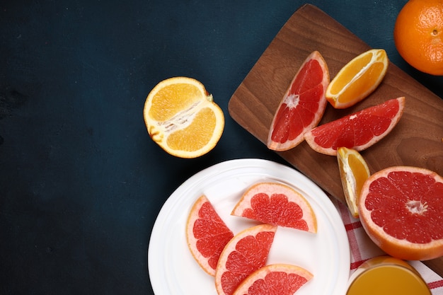 Orange and grapefuit slices on the blue background.