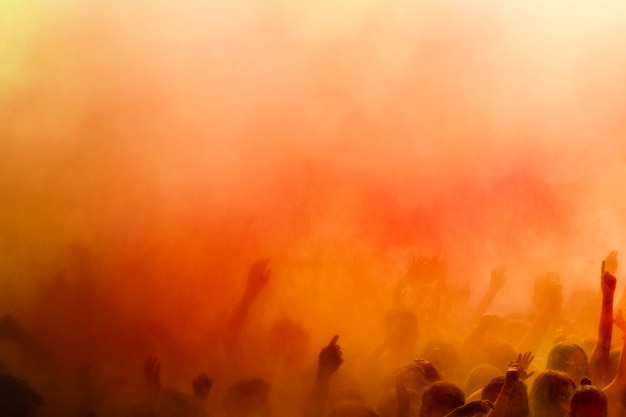 An orange holi colors over the crowd