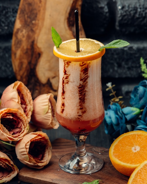 orange juice in glass garnished with orange slice