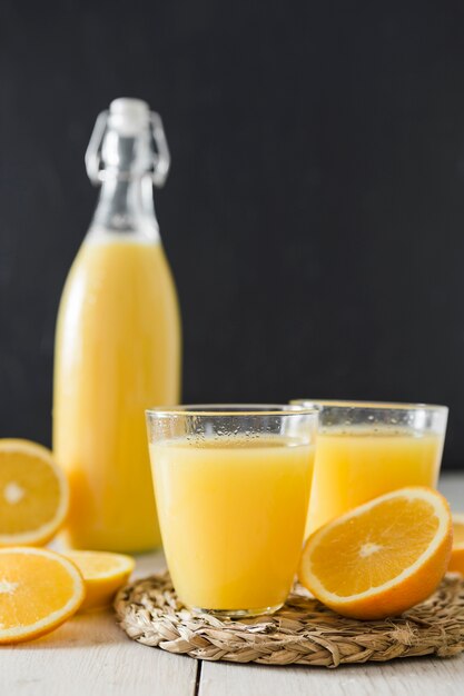 Orange juice glasses and bottle