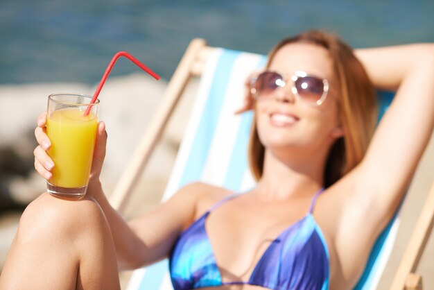 Orange juice with blurred woman
