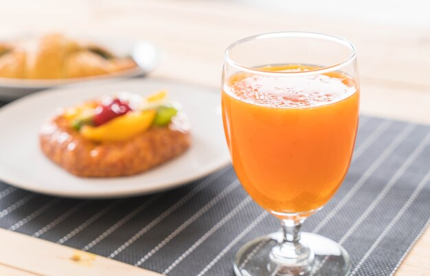 orange juice with spinach croissant and mixed fruits danish