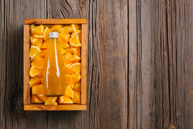 Orange juice on wooden background copyspace