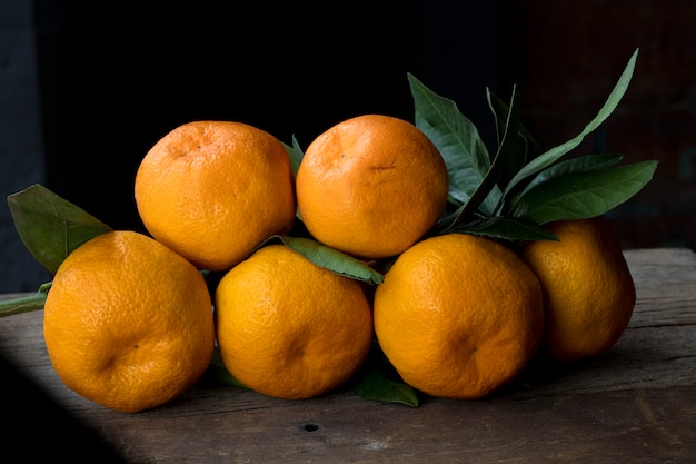 Orange mandarines with green leaves.