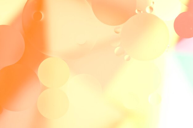 Orange oil drops on the water surface