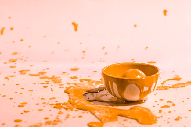 Orange paint splash and cup abstract background