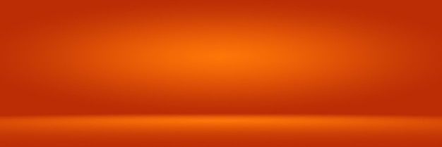 Free photo orange photographic studio background vertical with soft vignette soft gradient background painted canvas studio backdrop