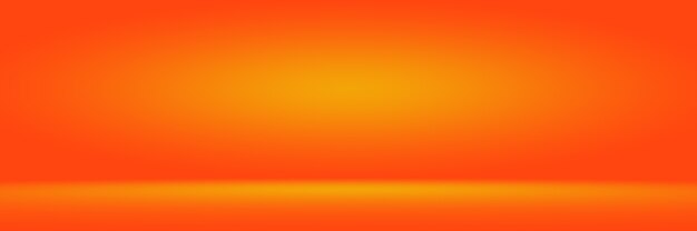 Orange photographic studio background vertical with soft vignette. soft gradient background. painted canvas studio backdrop.