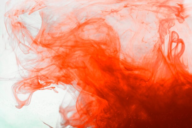 Orange pigment flowing in water