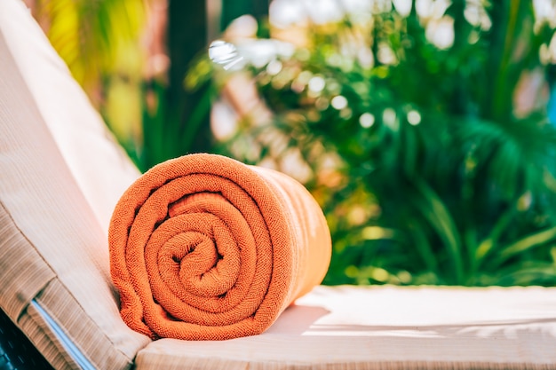 Orange pool towel on deck chair