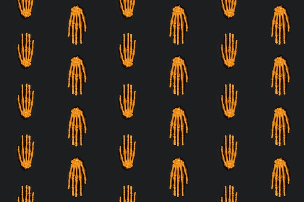 Orange skeleton hands laid in even lines