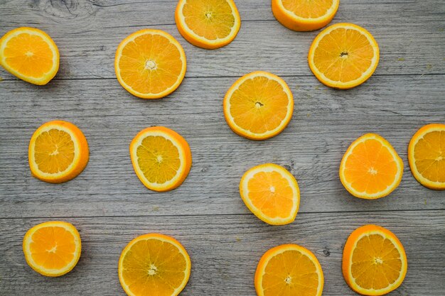 Orange slices on wooden background