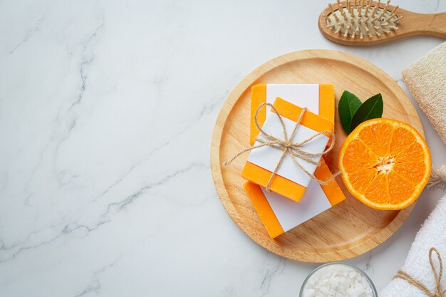 Orange soap with fresh orange on marble background