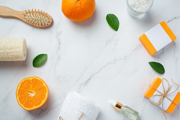 Orange soap with fresh orange on marble background