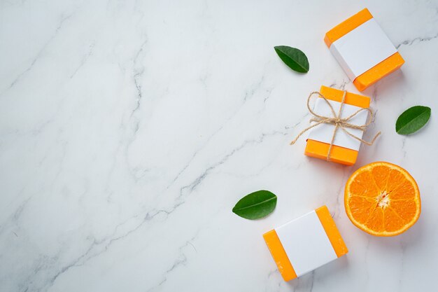 Orange soap with fresh orange on marble background